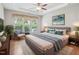 Bedroom featuring hardwood floors, a soft gray bed with throw blanket, an accent chair and leafy plant at 519 Garendon Dr, Cary, NC 27519