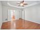 Open bedroom with hardwood floors features an elegant trey ceiling and double-door access to an ensuite bathroom at 519 Garendon Dr, Cary, NC 27519