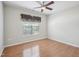 Spacious bedroom with modern ceiling fan, wood laminate flooring, and bright window at 519 Garendon Dr, Cary, NC 27519