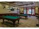 Entertaining billiards room with three tables, bar seating and televisions at 519 Garendon Dr, Cary, NC 27519