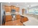 Well-equipped kitchen with stainless steel appliances, wooden cabinets, and granite countertops at 519 Garendon Dr, Cary, NC 27519