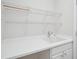 Clean laundry room with white cabinets, a sink, and wire shelving for storage at 519 Garendon Dr, Cary, NC 27519