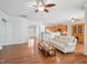 Open-concept living room with hardwood floors, ceiling fans, and seamless flow to the kitchen at 519 Garendon Dr, Cary, NC 27519