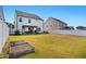 Expansive backyard with a pergola-covered dining area and a well-maintained lawn at 521 Glenwyck Ct, Fuquay Varina, NC 27526