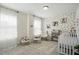 Serene Bedroom featuring a polka dot wall, crib, and rocking chair at 521 Glenwyck Ct, Fuquay Varina, NC 27526