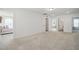 Large bonus room with neutral carpet, multiple doorways, and versatile space for various activities at 521 Glenwyck Ct, Fuquay Varina, NC 27526