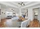 Open-concept dining area featuring a modern chandelier and seamless transition to the living room and kitchen at 521 Glenwyck Ct, Fuquay Varina, NC 27526