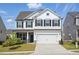 Charming two-story home with white siding, black shutters, and a two-car garage at 521 Glenwyck Ct, Fuquay Varina, NC 27526