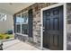 Close-up of the home's exterior showcasing a sleek black front door and stone facade at 521 Glenwyck Ct, Fuquay Varina, NC 27526
