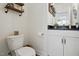 Clean half bathroom features granite countertops, white cabinets, and modern fixtures at 521 Glenwyck Ct, Fuquay Varina, NC 27526