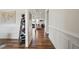 Elegant hallway features hardwood floors, white wainscoting, and views into the living area at 521 Glenwyck Ct, Fuquay Varina, NC 27526