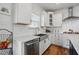 Close up of kitchen featuring stainless appliances, white cabinets, subway tile backsplash, and light countertops at 521 Glenwyck Ct, Fuquay Varina, NC 27526