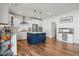Open-concept kitchen boasts stainless appliances, white cabinets, subway tile backsplash, and a large navy blue island at 521 Glenwyck Ct, Fuquay Varina, NC 27526