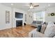 Comfortable living room featuring a fireplace, large television, and neutral decor at 521 Glenwyck Ct, Fuquay Varina, NC 27526