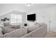 Comfortable living room with large TV, plush sofa, and window bench seating at 521 Glenwyck Ct, Fuquay Varina, NC 27526