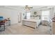 Spacious main bedroom features a tray ceiling, ceiling fan, and large windows at 521 Glenwyck Ct, Fuquay Varina, NC 27526