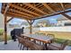 Outdoor patio with a pergola, dining table, and grill, perfect for entertaining guests at 521 Glenwyck Ct, Fuquay Varina, NC 27526