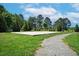 Outdoor sand volleyball court surrounded by greenery and a walking path at 521 Glenwyck Ct, Fuquay Varina, NC 27526