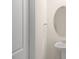 Bathroom with pedestal sink and oval mirror at 5520 Musket Ct, Raleigh, NC 27610