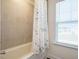 A bathtub is featured with stylish shower curtain and window at 555 Whitley Ridge Dr, Clayton, NC 27527