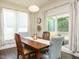 Well-lit dining room featuring wood table and access to patio at 555 Whitley Ridge Dr, Clayton, NC 27527