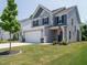 Charming two-story home with a well-manicured lawn and an attached two-car garage at 555 Whitley Ridge Dr, Clayton, NC 27527
