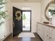 Welcoming foyer featuring wood floors, decorative wreath, and a stylish accent table at 555 Whitley Ridge Dr, Clayton, NC 27527