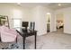 Comfortable home office has neutral carpet, a black desk and two monitors, with a pink chair and open doorway at 555 Whitley Ridge Dr, Clayton, NC 27527