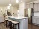 Bright kitchen with gray cabinets, island, and stainless appliances at 555 Whitley Ridge Dr, Clayton, NC 27527