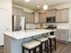 Modern kitchen with stainless steel appliances, island, and gray cabinets at 555 Whitley Ridge Dr, Clayton, NC 27527