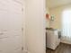 Bright laundry room featuring a white washer and dryer and a wire rack shelf with cleaning supplies at 555 Whitley Ridge Dr, Clayton, NC 27527