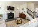 Cozy living room features a fireplace, television, and staircase at 555 Whitley Ridge Dr, Clayton, NC 27527