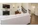 Cozy living room featuring a fireplace, staircase, and comfortable seating arrangement at 555 Whitley Ridge Dr, Clayton, NC 27527