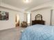 Serene main bedroom boasts a tray ceiling, beige chair and a glimpse of a bathroom nearby at 555 Whitley Ridge Dr, Clayton, NC 27527