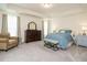 Inviting main bedroom features a tray ceiling, neutral carpet, stylish furniture, and ample natural light at 555 Whitley Ridge Dr, Clayton, NC 27527