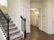Elegant staircase with dark wood railings, leading to the upper level of the home at 555 Whitley Ridge Dr, Clayton, NC 27527