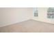 A bright bedroom with neutral carpet and two windows providing natural light at 6036 Sodium St, Raleigh, NC 27610