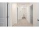 Carpeted hallway with access to other rooms and a laundry area at 6036 Sodium St, Raleigh, NC 27610