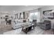 Bright living room with large windows, neutral tones, and modern furnishings flowing into the dining area at 6041 Sodium St, Raleigh, NC 27610