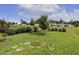 The grassy backyard is on a hill. There are some young trees planted in the yard at 624 Meadowgrass Ln, Wake Forest, NC 27587