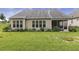 Picture of the backyard showing the screened porch and many flowering plants at 624 Meadowgrass Ln, Wake Forest, NC 27587