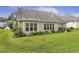 Grassy backyard lined with mature shrubbery and flowering plants at 624 Meadowgrass Ln, Wake Forest, NC 27587
