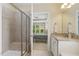 Bathroom featuring tiled shower, granite countertops, and open view into bedroom at 624 Meadowgrass Ln, Wake Forest, NC 27587