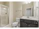 Well-lit bathroom showcases a glass shower and a vanity with ample storage space at 624 Meadowgrass Ln, Wake Forest, NC 27587