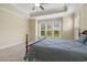 Bright bedroom featuring tray ceiling, carpet floors, and abundant natural light at 624 Meadowgrass Ln, Wake Forest, NC 27587