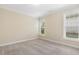 Bright bedroom featuring neutral walls, plush carpeting, and ample natural light from two large windows at 624 Meadowgrass Ln, Wake Forest, NC 27587