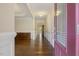 Warm and inviting foyer with hardwood floors, elegant trim, and a glimpse into the dining room at 624 Meadowgrass Ln, Wake Forest, NC 27587