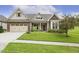 Single Gathering home featuring brick accents, a well-manicured lawn, and a driveway at 624 Meadowgrass Ln, Wake Forest, NC 27587