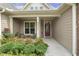 Inviting front porch with chairs, decorative plants, and a stylish front door at 624 Meadowgrass Ln, Wake Forest, NC 27587