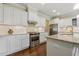 Modern kitchen featuring white cabinets, granite countertops, stainless steel appliances, and hardwood floors at 624 Meadowgrass Ln, Wake Forest, NC 27587